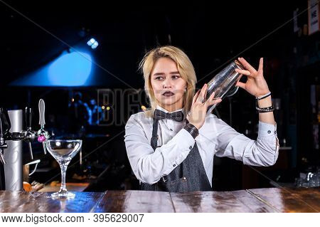 Charismatic Woman Bartending Demonstrates The Process Of Making A Cocktail Behind Bar