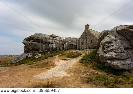 House Between Rocks In Meneham On The Atlantic Coast In Northern Brittany (france), Cloudy Day In Su