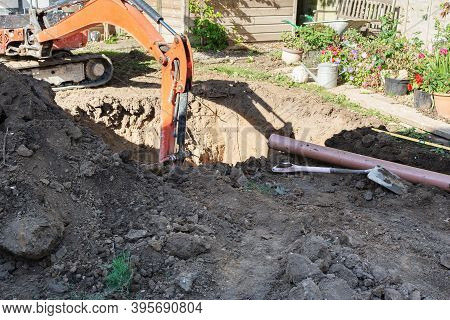 Mini Digger In The Garden Excavating The Ground