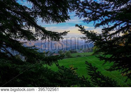 Mountains Landscape During Sunset Sky Across Fir Tree Branches Frame. Natural Background. Copy Space