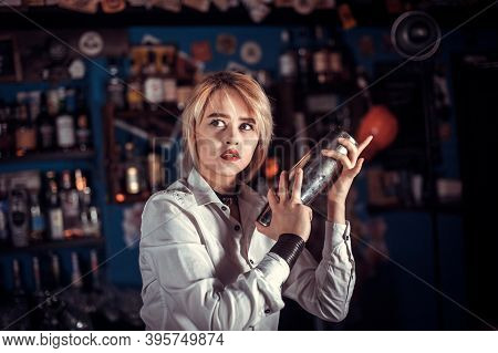 Girl Barman Concocts A Cocktail At The Brasserie