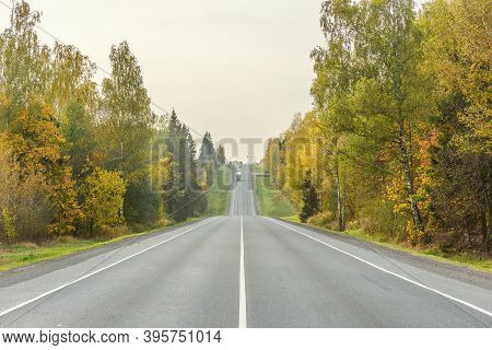 Long Straight Highway At Autamn Day Time.