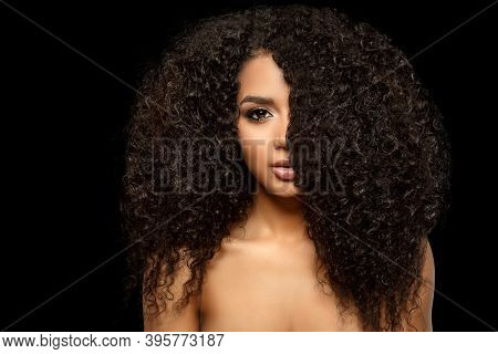 Beauty black skin woman African Ethnic female face. Young african american model with long afro hair. Lux model on black.