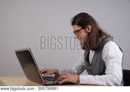 Programming And Application Development, A Young Man Writes Code Sitting At A Laptop. Training In Pr