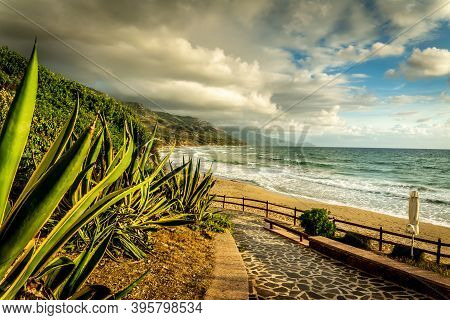Dramatic Sky Over La Speranza Beach In Alghero At Sunset. Sardinia, Italy
