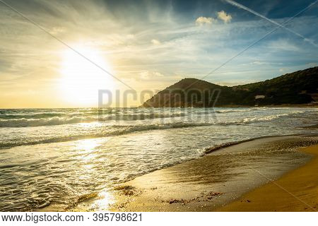 Cloudy Sky Over La Speranza Beach At Sunset. Sardinia, Italy