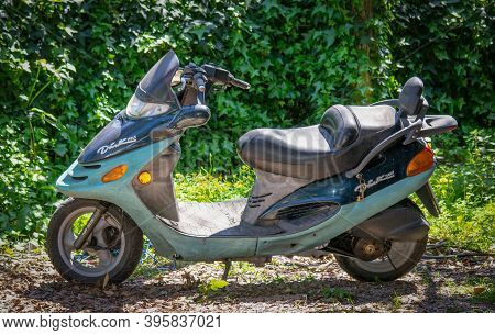 Sassari, Ita - April 17, 2013: Old Scooter Parked In A Green Garden On A Sunny Day