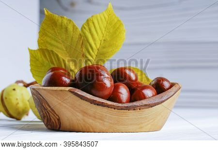 Chestnut Fruit In Oldwooden Bowl On A White Background.
