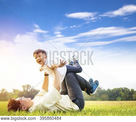 Happt Father And Son Playing In The Park