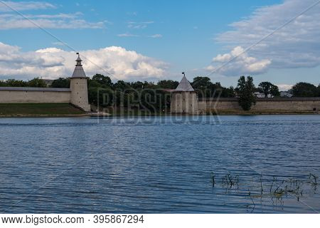 The High And The Flat Tower In Pskov Krom (kremlin). River Pskova Creek. Russia