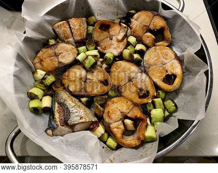 Bonito Fish Pieces With Leek And Vegetables Baked In Oven With Pan / Baking Parchment Paper.