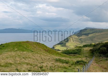 Scottish Landscape With Hills And Shoreline Near Staffin At Isle Of Skye With Green Pastures And A F