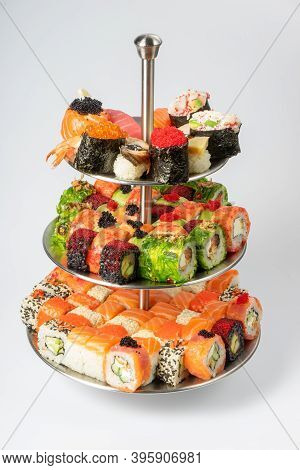 A Large Beautiful Set Of Different Types Of Sushi Maki, Nigiri And Gunkans On A Three-tiered Plate