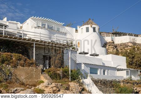 Whitewashed Greek Houses On The Cliff Side At Vlychada Harbor On The Santorini Island. Greece