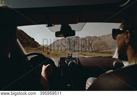 Couple Driving Car View From Car Interior To Mountains Auto Trip. High Quality Photo