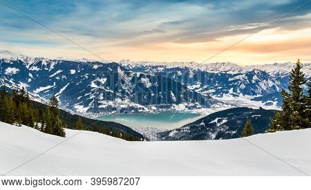 Zell Am See And Schmitten Town At Zeller Lake In Winter. View From Schmittenhohe Mountain, Snowy Ski