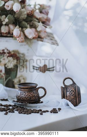 A Cup Of Cappuccino With Coffee Bean As Background