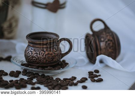 A Cup Of Cappuccino With Coffee Bean As Background