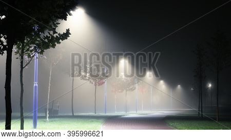 Lanterns On The Street Of The Night City In The Fog.