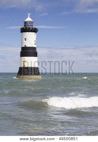 Lighthouse and waves at Penmon Point