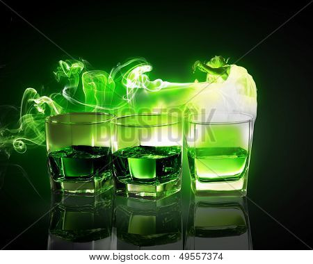 Three glasses of green absinth