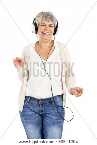 Elderly woman dancing while listen music with headphones, isolated over white background