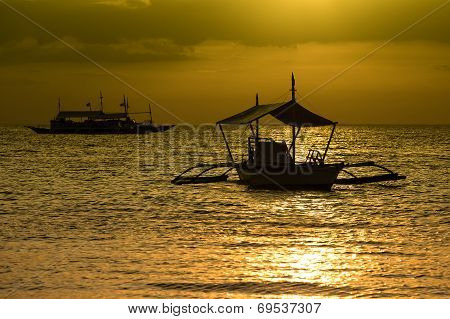 Philippine Tourist Boat Sails On The Sea At Sunset.