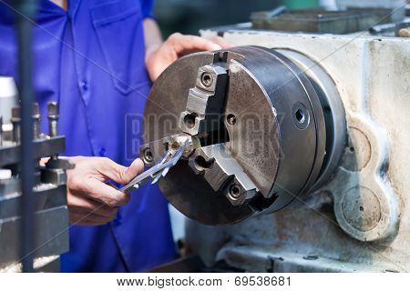 Milling Machine Operator Working In Factory Workshop
