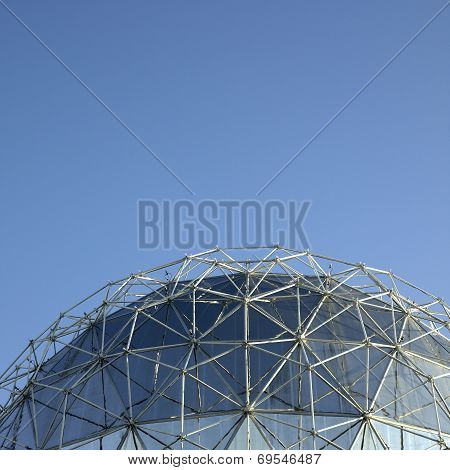 Large silver geodesic dome and blue sky
