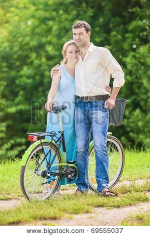 Happy Couple Together With Bicycle. Positive Expression