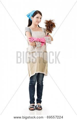 Portrait of Asian housewife using feather duster, full length portrait on white background.