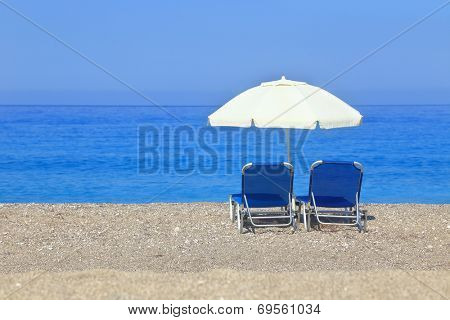 Sandy beach with parasol and two sunbeds, Gialos Lefkada 