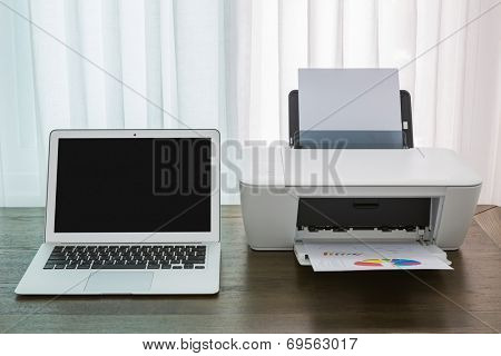 printer and Laptop on wood table