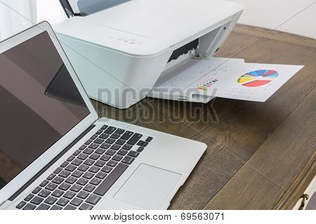 printer and Laptop on wood table