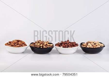 Assorted nuts in ceramic bowls