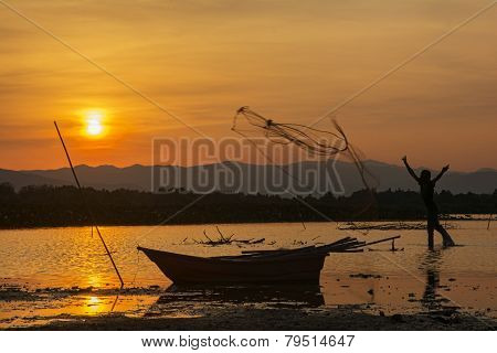 silhouette man fishing and sunset in Thailand