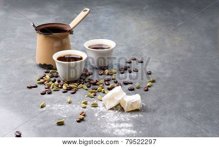 Turkish Coffee with coffee beans and Cardamom scattered on a vintage background