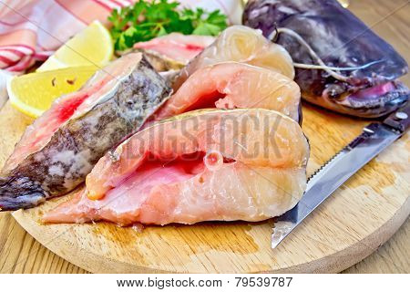 Catfish raw with knife on board
