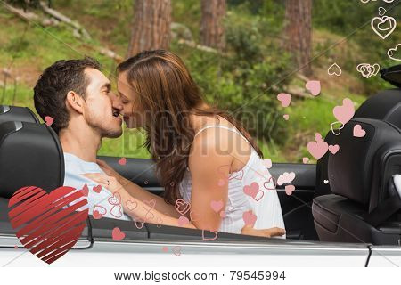 Young couple smooching on the backseat against heart