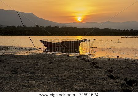 silhouette fishing boat and sunset