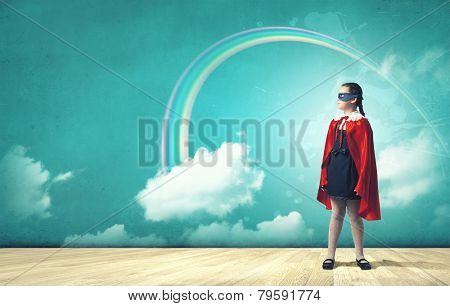 Cute girl of school age wearing super hero costume