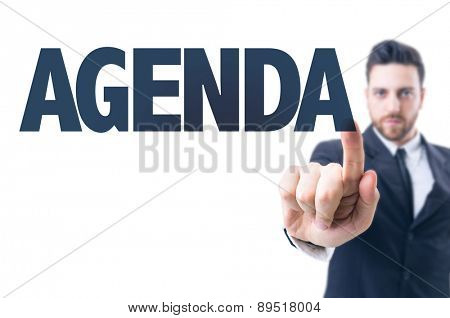 Business man pointing the text: Agenda