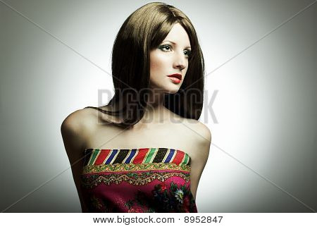 Fashion portrait of the young woman in studio