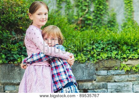 Outdoor portrait of two adorable kids