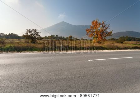 Side View Of Empty Asphalt Road In Mountain Area
