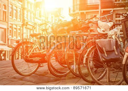Amsterdam view with bicycles under sun light