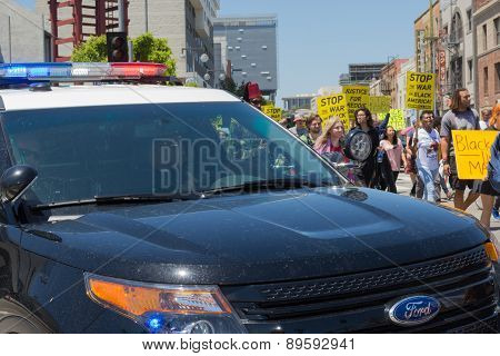 Police Watching Protestants In The Streets With Signs