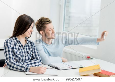 Students take a selfie picture in a classroom