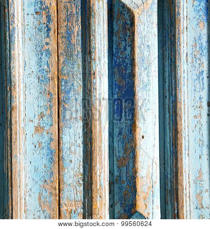 Dirty Stripped Paint In The Blue Wood Door And Rusty Nail