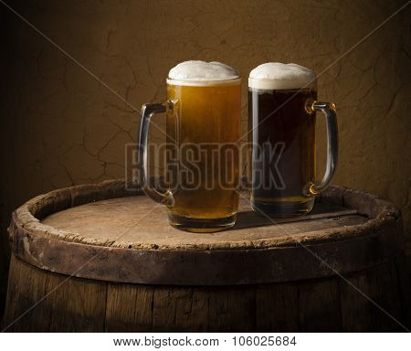 Still life: old wooden pint of beer, glass of beer on the table in the cellar.